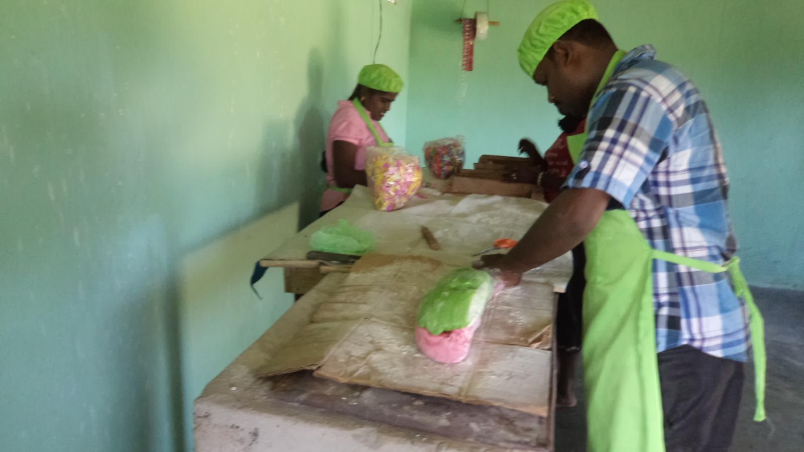 people standing on benches and making sweets