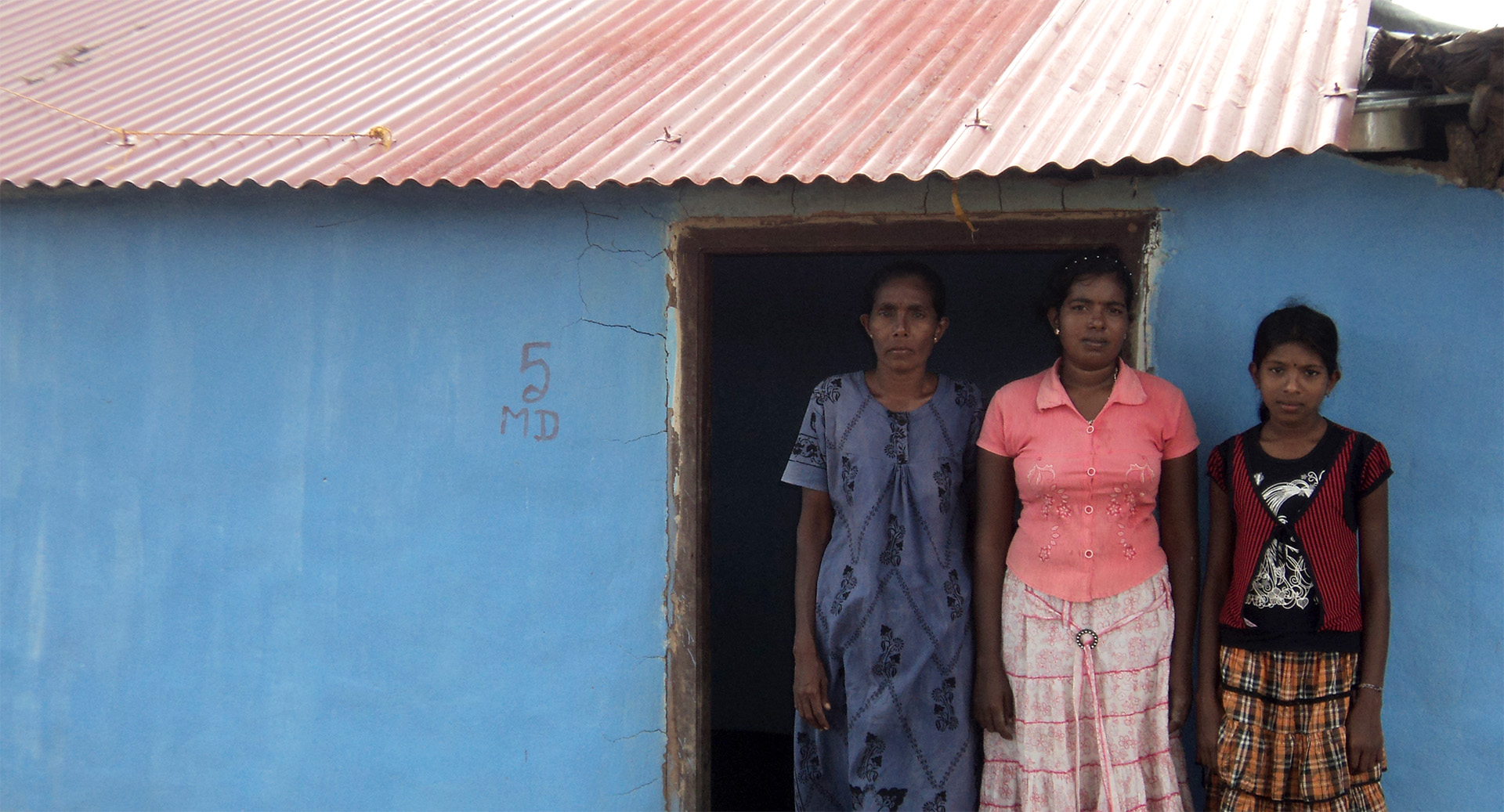 three mdsl supported women standing in front of cabin